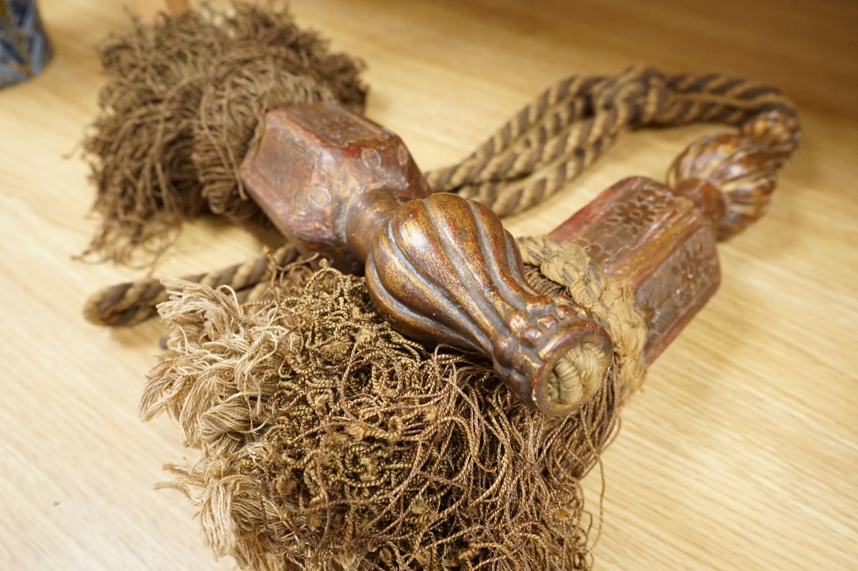 A pair of 19th century Venetian carved wood and tasseled tie-backs